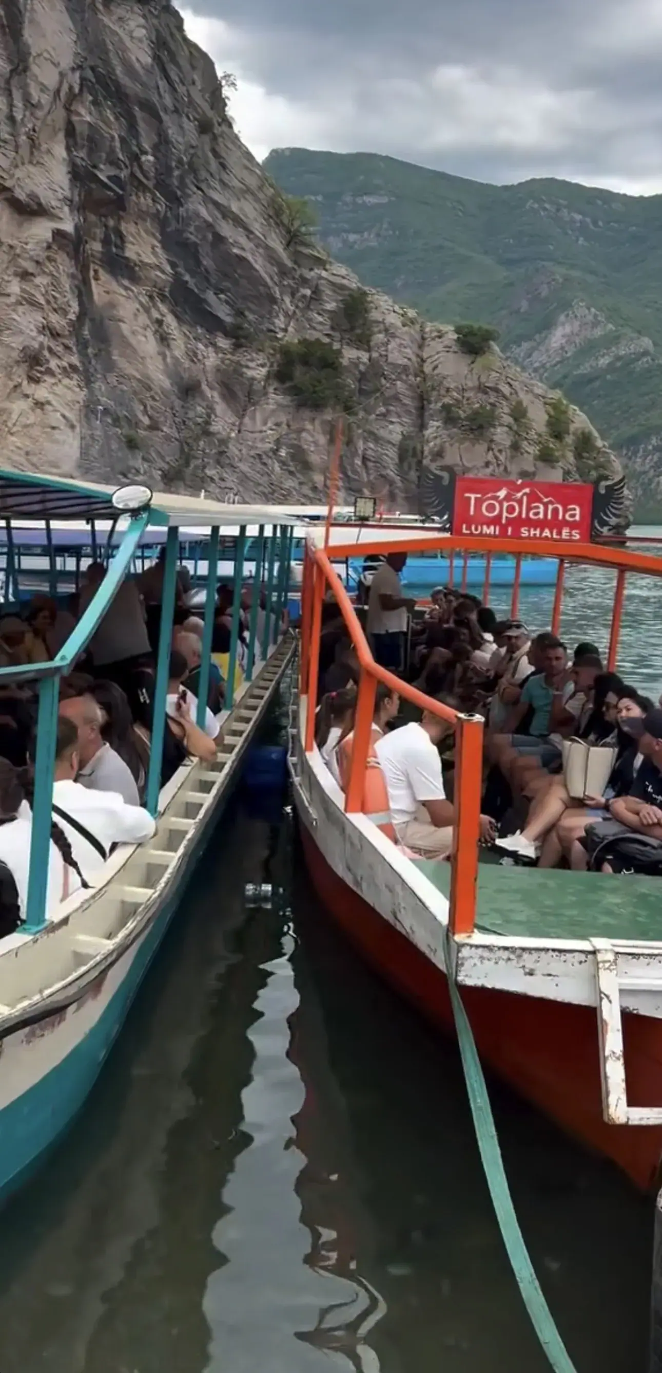 Toplana boats travelling between the mountains on the Shala River